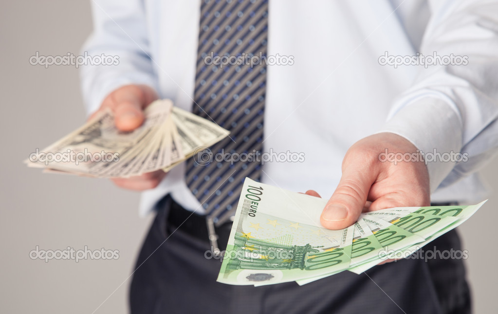 Businessman's hands giving banknotes to you