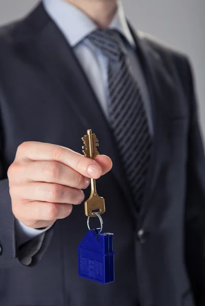 Businessman offering a key — Stock Photo, Image