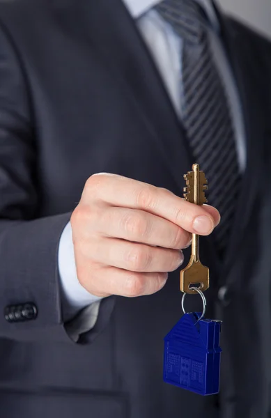 Businessman offering a key — Stock Photo, Image