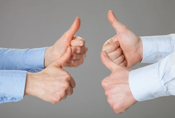 Businessmen holding their thumbs up — Stock Photo, Image