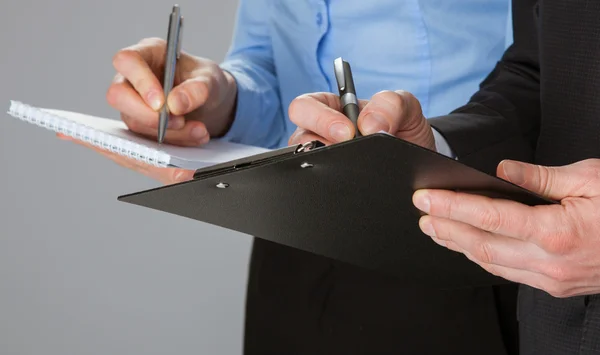 Closeup of working business team taking notes — Stock Photo, Image