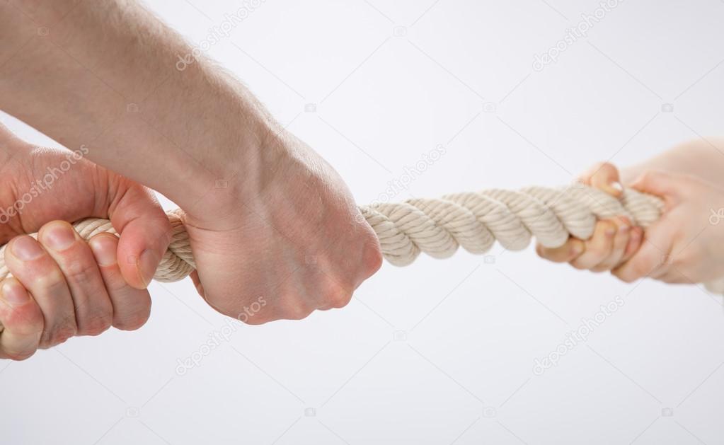 Hands pulling a rope