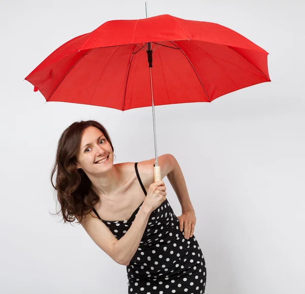 Pretty young woman in dress with open umbrella — Stock Photo, Image