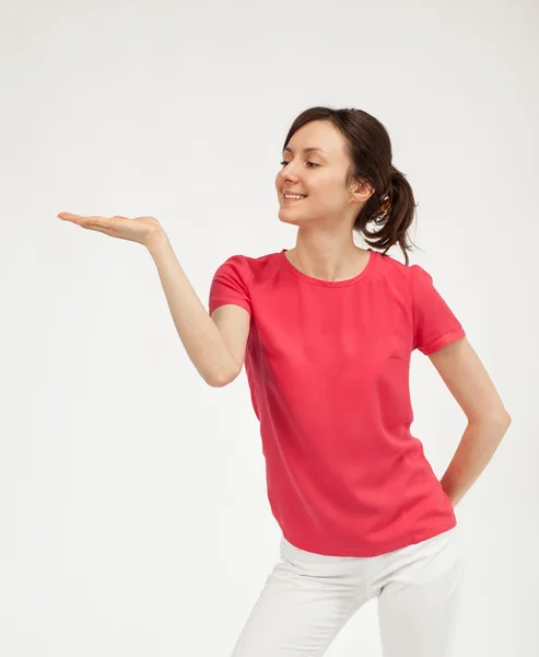 Beautiful young woman holding something in her hand — Stock Photo, Image