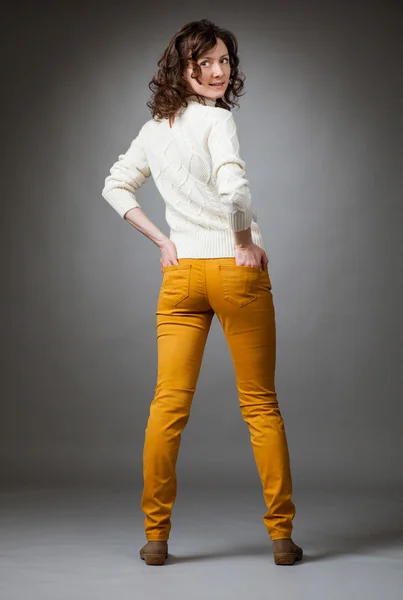 Happy young woman posing in a studio — Stock Photo, Image