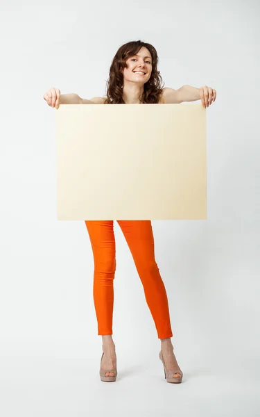 Joyful young woman holding blank placard — Stock Photo, Image