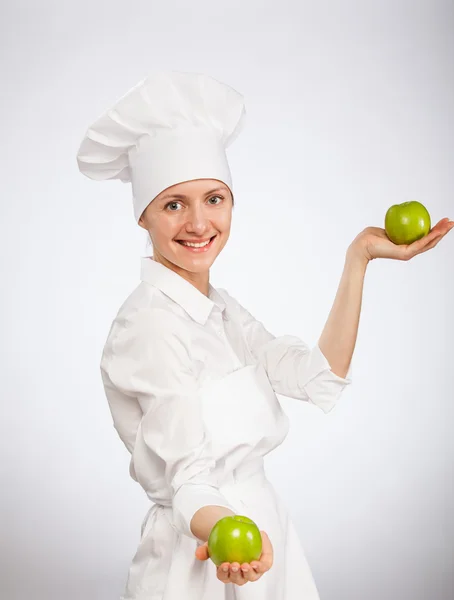 Kobieta kucharz wyświetlone jabłka — Zdjęcie stockowe