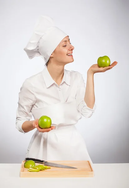 Female cook showing apples — Stock Photo, Image