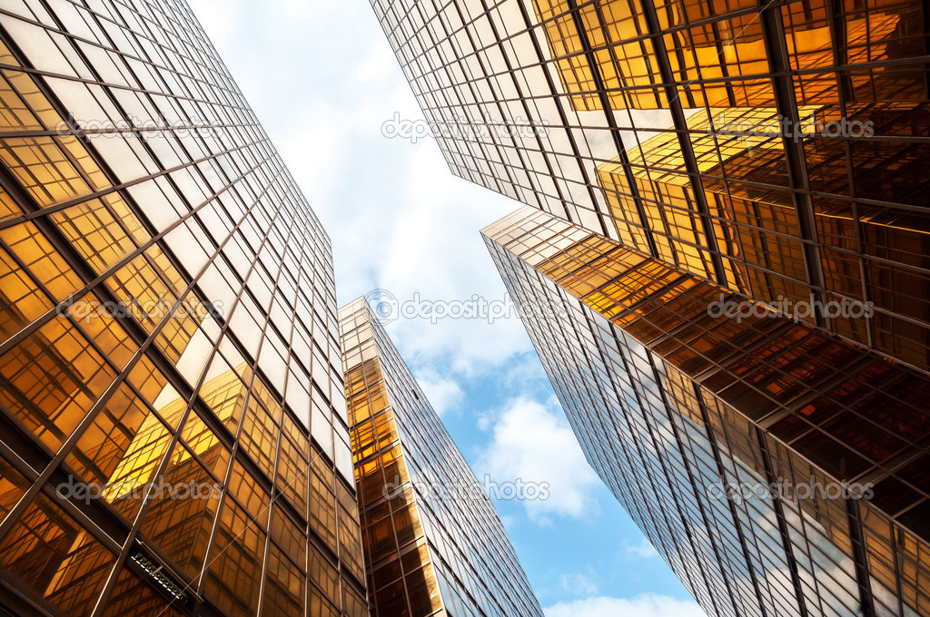 Modern glass skyscraper with blue sky and white clouds, Hong Kong