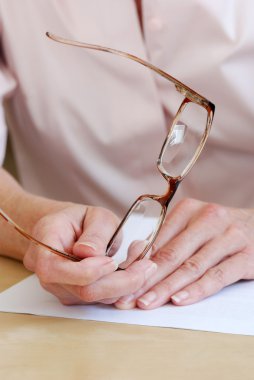 Female hands holding eye glasses clipart
