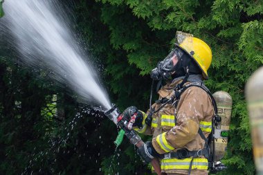 Firefighter at work during a house fire, with respiratory protection equipment