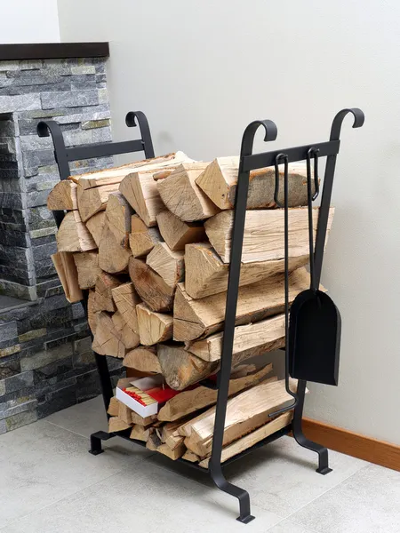 Firewood em suporte de metal — Fotografia de Stock