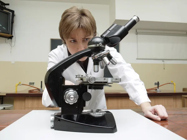 Chemistry teacher with microscope — Stock Photo, Image