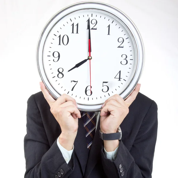 Businessman holding clock to show time — Stock Photo, Image