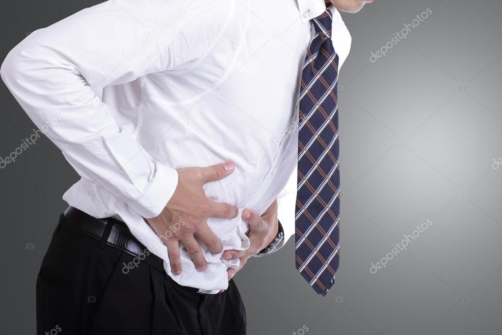 businessman holding stomach for show his stomachache
