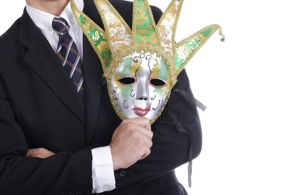 Empresário segurando máscara branca — Fotografia de Stock