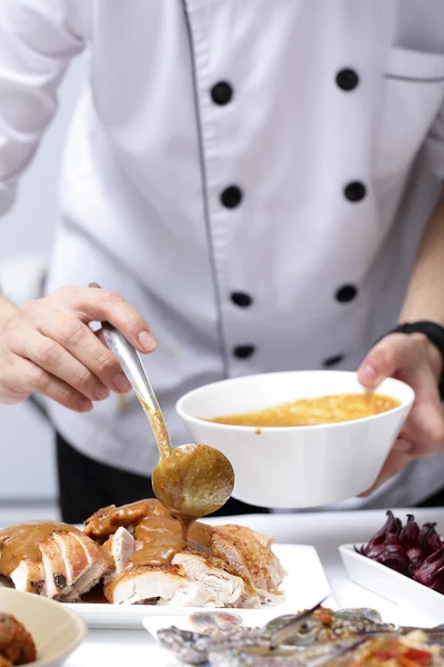 Chef apply chicken soup to Roast Turkey