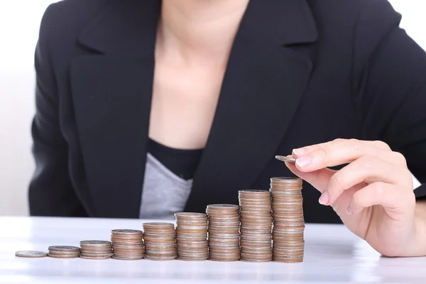 Las mujeres de negocios ponen dinero de pila de monedas —  Fotos de Stock