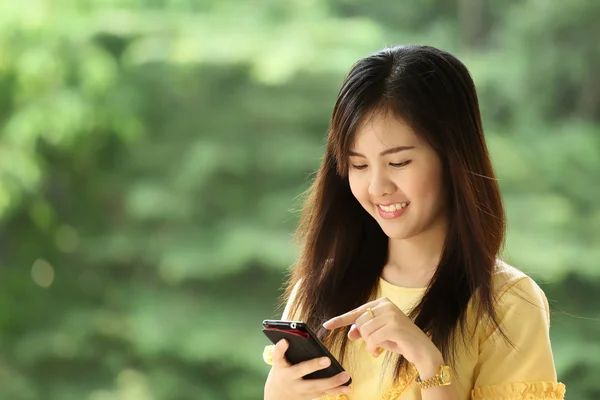 Portrait lovely girl type information with her mobile phone — Stock Photo, Image
