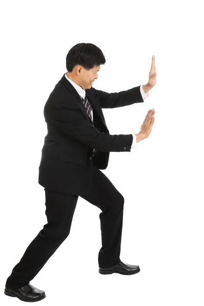 Businessman push something away from his business Stock Photo