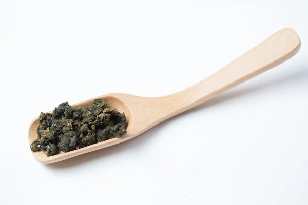 Tea leaves and wooden scoop — Stock Photo, Image