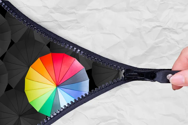 Open zip to show Leader holding multiple color umbrella — Stock Photo, Image