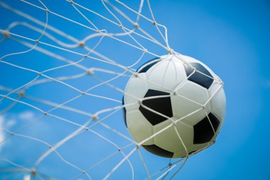 Soccer ball in the goal after shooted  clipart