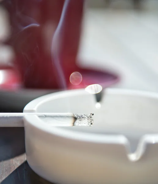 Burning cigarette in the ashtray — Stock Photo, Image