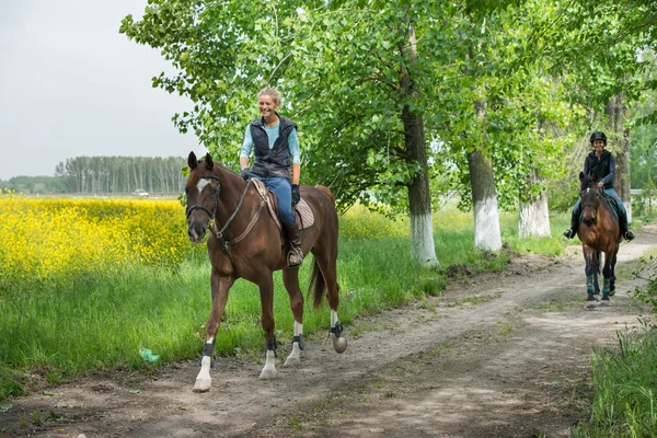 Girls on horseback riding — Stock Photo, Image