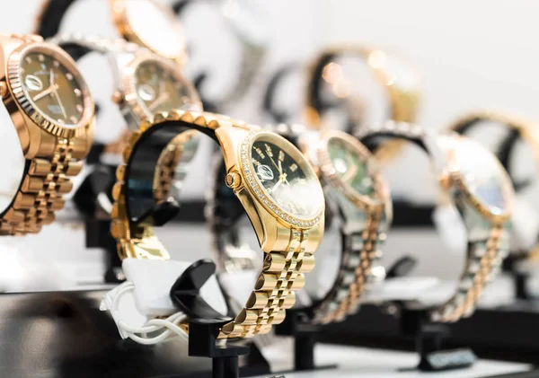 Luxury  watches on display in store window, shallow depth of field.