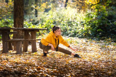 girl exercise in the autumn forest
