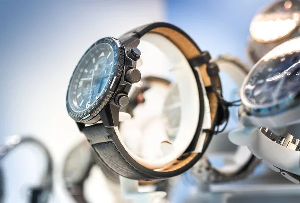 Luxury  watches on display in store window, shallow depth of field.