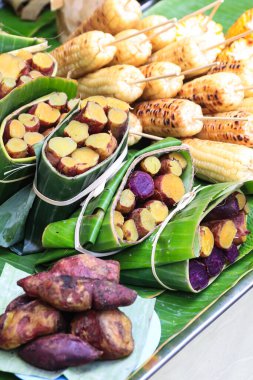 Thai Sweet potatoes steamed and wrapped in banana leaf package at street food in thailand