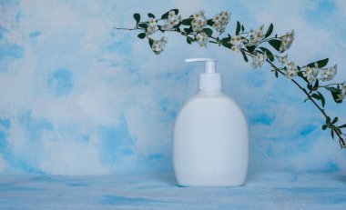 Saf beyaz, plastik, konteynır. Kozmetik, krem, saç maskesi, tıbbi ve güzellik ürünleri için ambalaj, şişe şablonu. Beyaz-mavi arkaplan.