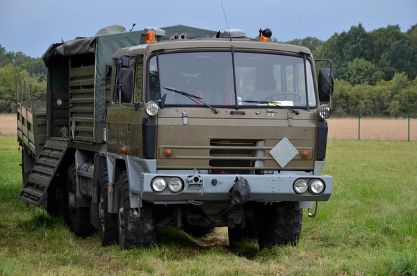 Военный тяжелый грузовик припаркован на лугу — стоковое фото