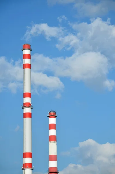 Two factory chimneys with sky in the background — Stock Photo, Image