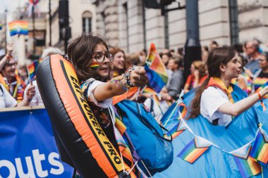 London / UK - 02/07/2022: People with flags and banners celebrating London LGBTQ Pride Parade