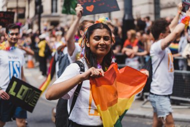 London / UK - 02/07/2022: People with flags and banners celebrating London LGBTQ Pride Parade