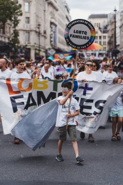 London / UK - 02/07/2022: LGBTQ+ families with flags and banners celebrating London LGBTQ Pride Parade