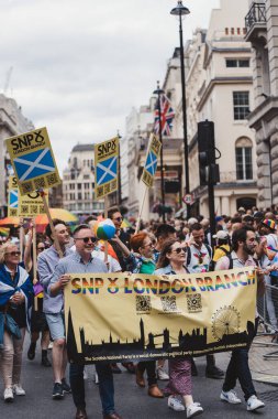London / UK - 02/07/2022: People with flags and banners celebrating London LGBTQ Pride Parade