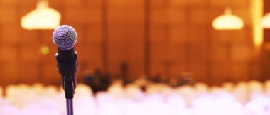Konser salonunda ya da konferans odasında sahne ışıklarında mikrofonu kapat. Uzay afişini kopyala. yumuşak odak.