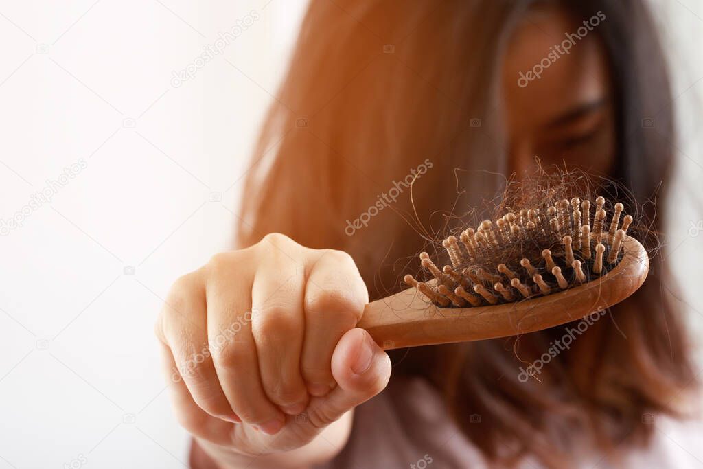 young woman worried about Hair loss problem after comb in hand. problem hormonal disbalance, stress concept. Health care concept