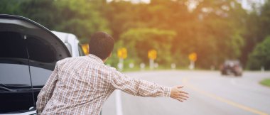 Stres altındaki genç adam bozuk araba kazasında sorun yaşıyor. Motor arızası var. Yardım bekle..