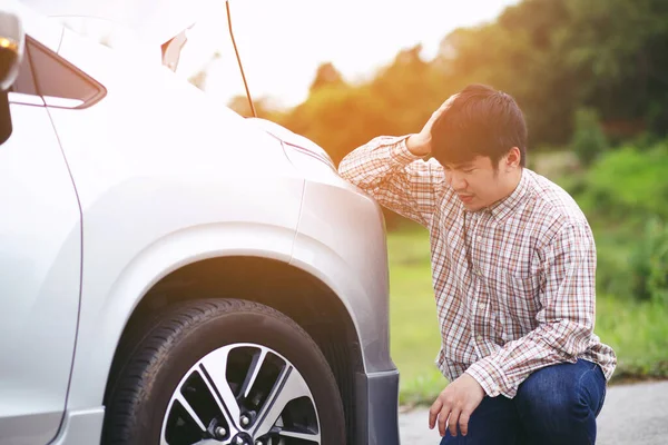 young stressed man having trouble with his Stress broken car  Engine room crash at failed engine Wait for help.