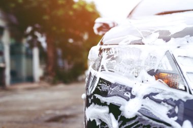 Outdoor car wash with foam soap.	