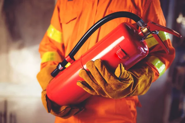 Fireman Hand Holding Fire Extinguisher Available Emergencies Conflagration Damage Background — Stock Photo, Image