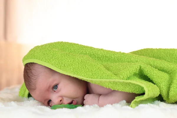 A portrait of crying baby with a blanket over his head — Stock Photo, Image