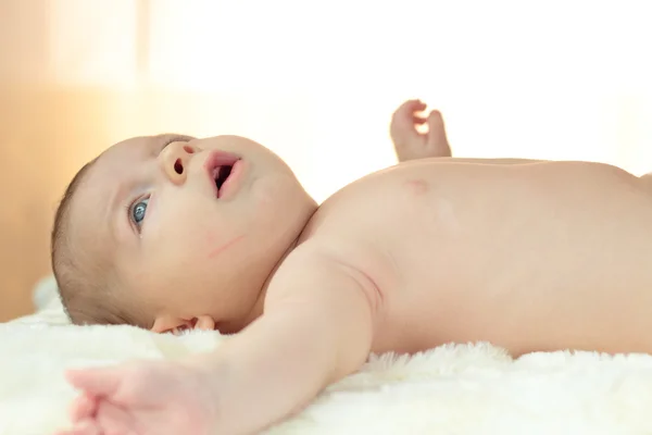 Cute little baby boy lying on his back — Stock Photo, Image