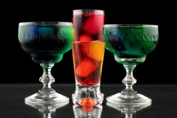 Closeup of some glasses with cocktails of different colors in nightclub — Stock Photo, Image