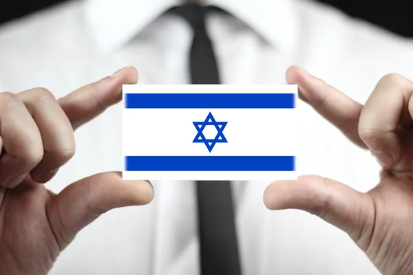 Empresario con una tarjeta de visita con una bandera de Israel —  Fotos de Stock